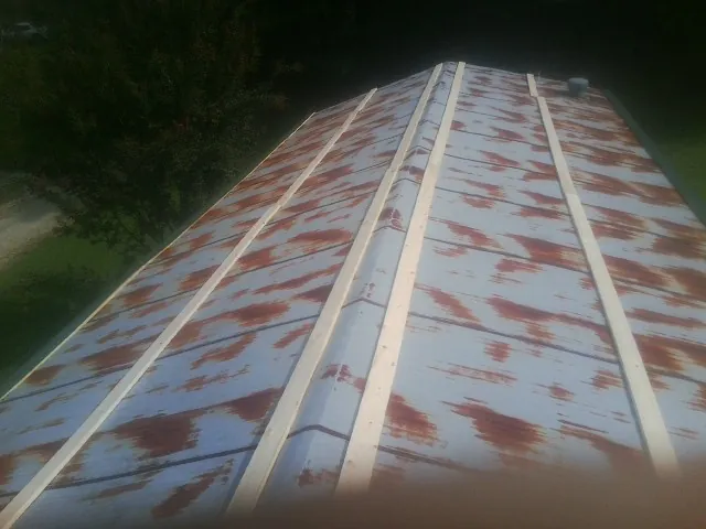 Rusted metal roof panels with new wood purlins before replacement — Storm Damage Roof Repair in Kingston by Roofing Brothers